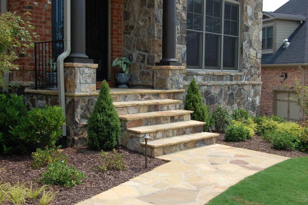 Stone walkway and stone steps in front yard